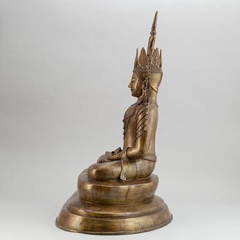 A seated buddha, yellow metal, possibly Nepal, 20th century.