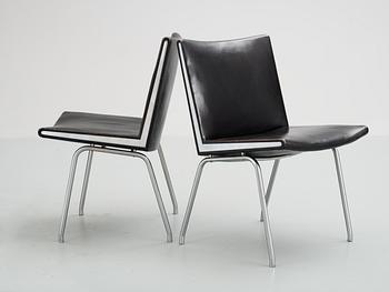 A pair of Hans J Wegner 'Kastrup' steel and black leather chairs, AP-stolen, Denmark.