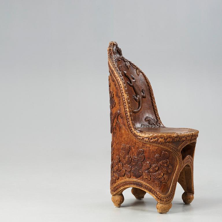 Knut Fjaestad, an Art Nouveau folk art sculptured pine chair, Sweden early 1900's.