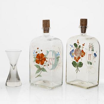 A birch veneered case with two bottles and a glass.