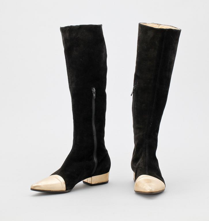 A pair of black suede boots by Versace.