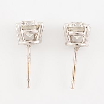 A pair of earrings in 18K white gold set with two round brilliant-cut diamonds, likely Tiffany & Co.