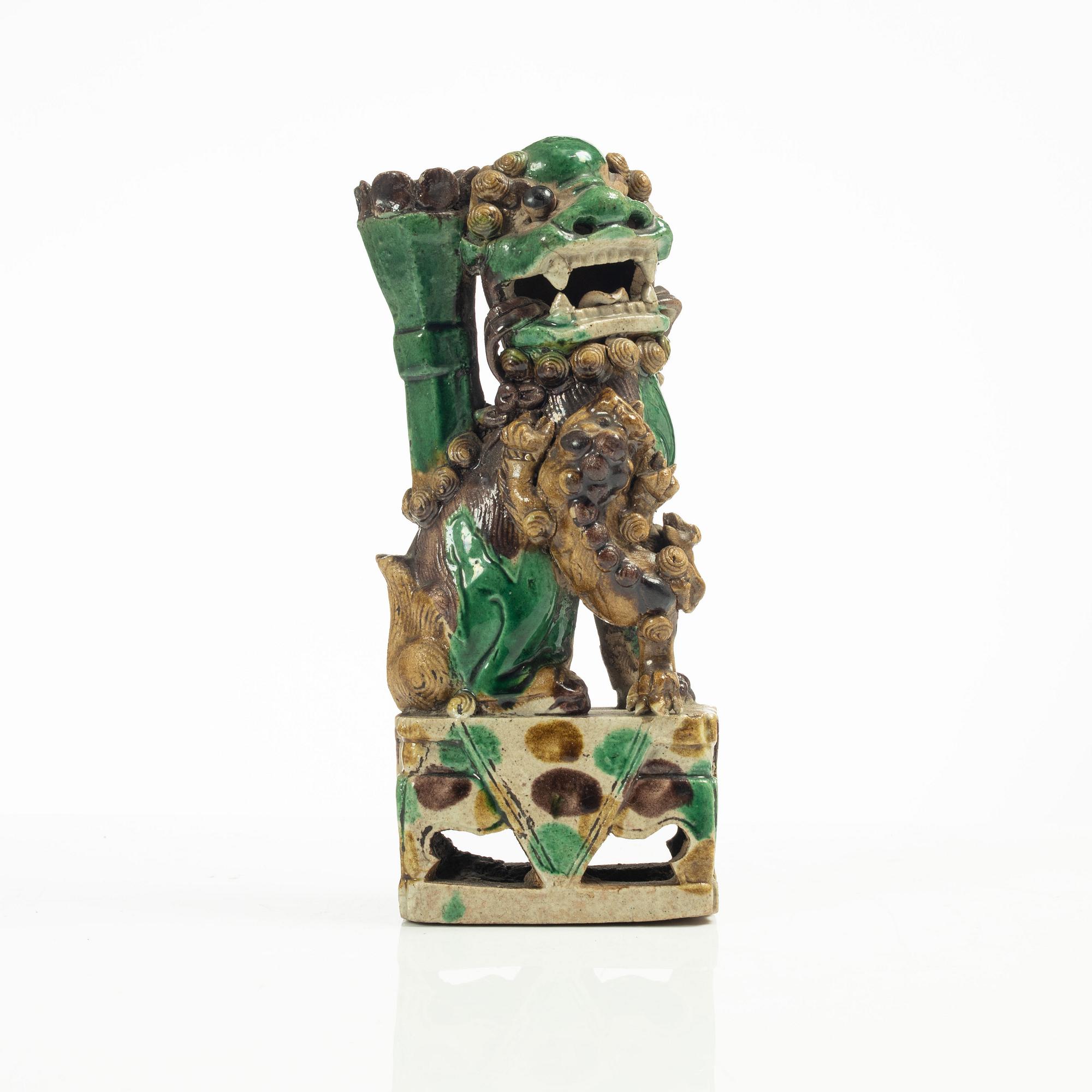 A Sancai glazed Buddhist lion incense/joss stick holder, Qing dynasty, Kangxi (1662-1722).
