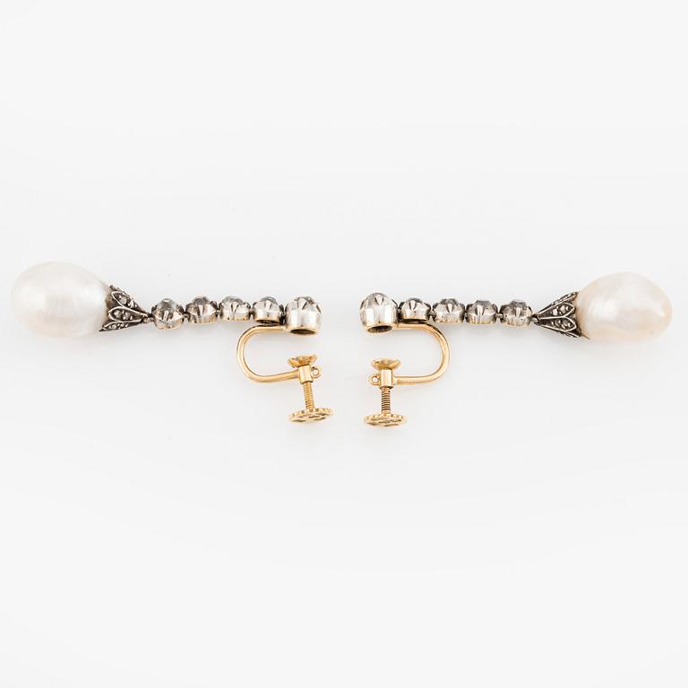 A pair of silver and gold earrings with drop-shaped pearls and old- and rose-cut diamonds.