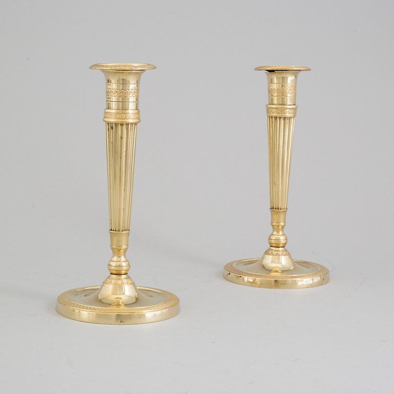 A pair of early 19th century bronze candlesticks.