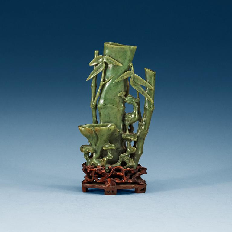 A  carved green stone sculpture, late Qing dynasty.