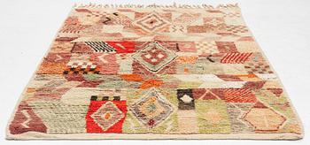 A Moroccan crpet, c. 240 (+7+8 cm flat weave) x 151 cm.