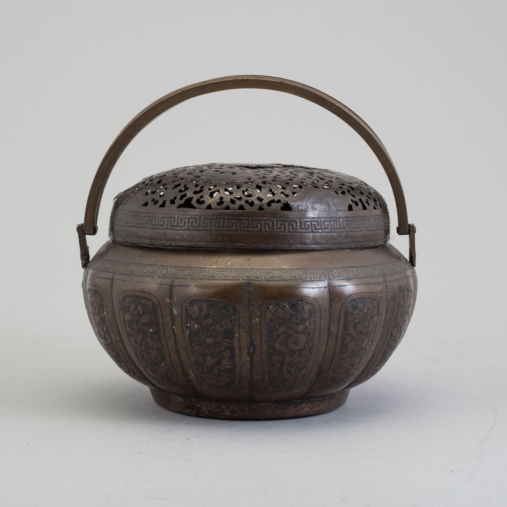 A Chinese engraved bronze hand warmer, late Qing dynasty,