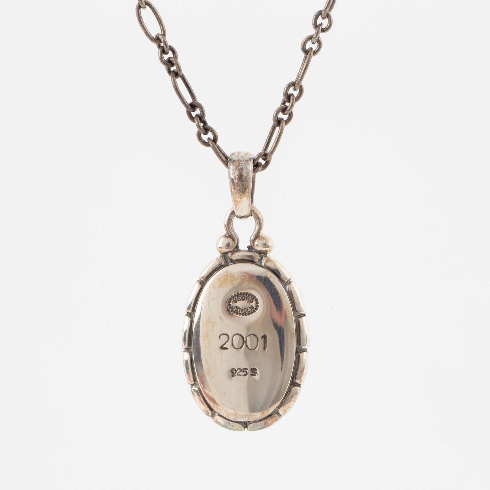 A Georg Jensen silver and cabochon-cut amber necklace.