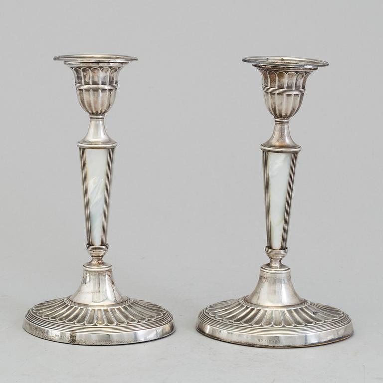 HARRISON BROTHERS & HOWSON, a pair of silver and mother of pearl candlesticks from Sheffield, England, 1926.