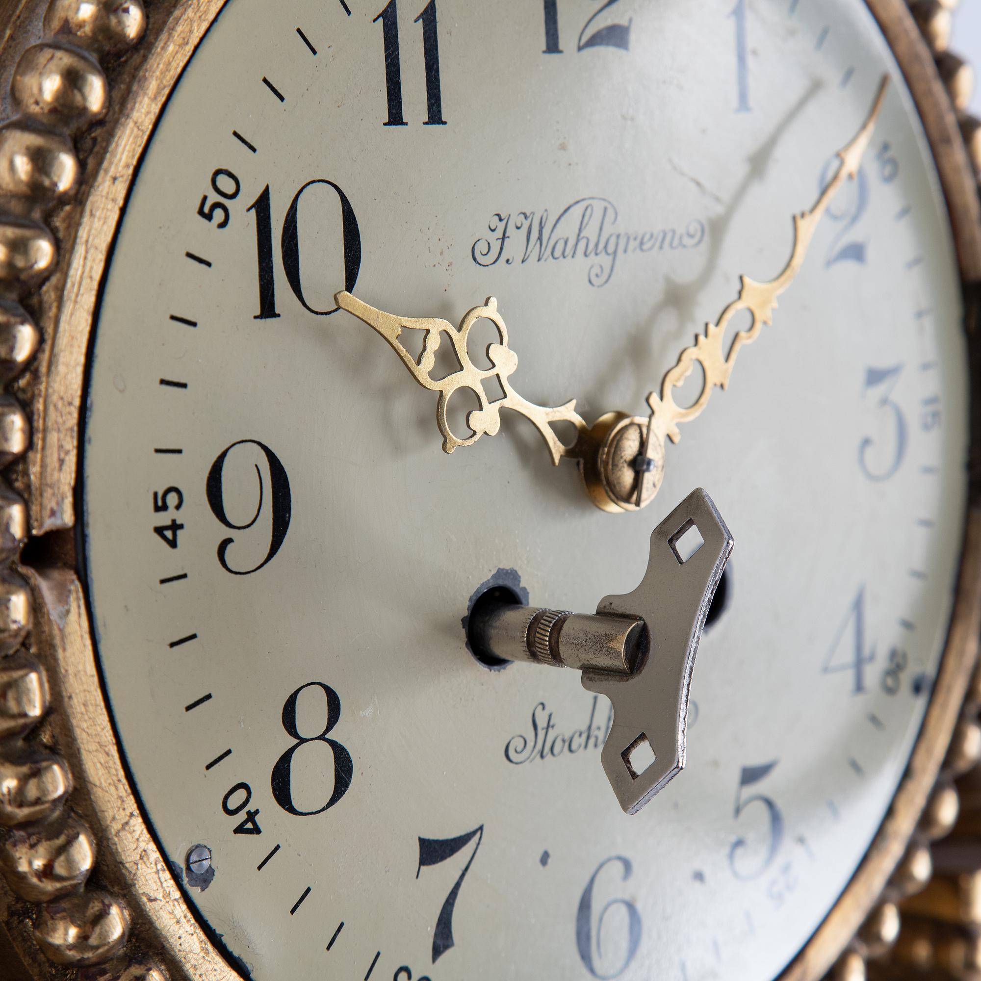 A 20th century gustavian style wall clock.