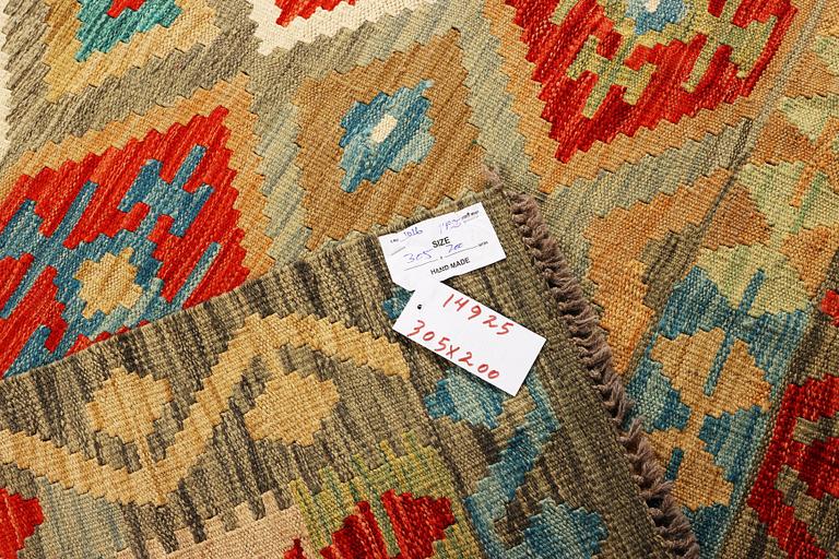 An Afghan Kilim carpet, c. 305 x 200 cm.