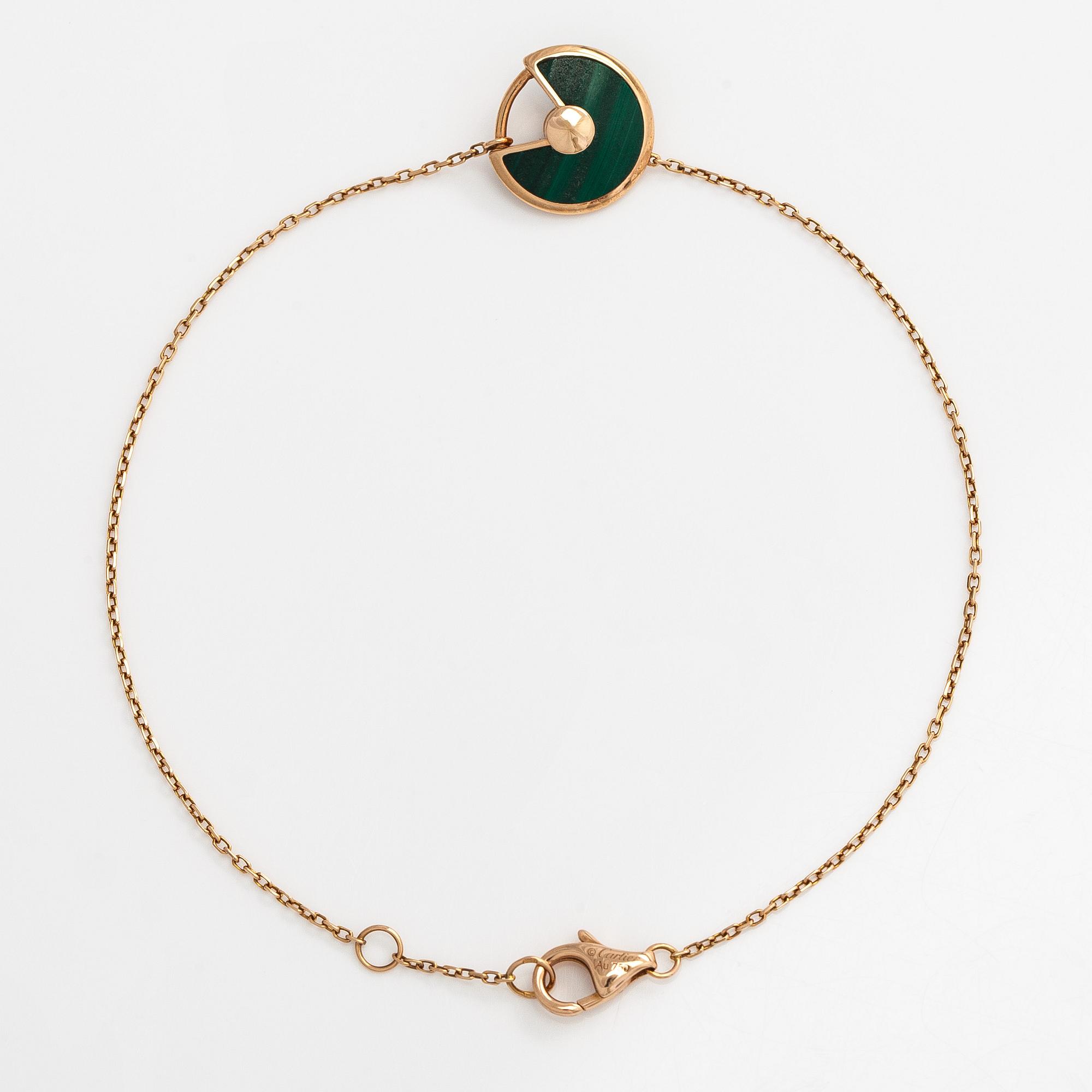 Cartier, an 18K gold "Amulette de Cartier" bracelet with malachite and a brilliant-cut diamond.