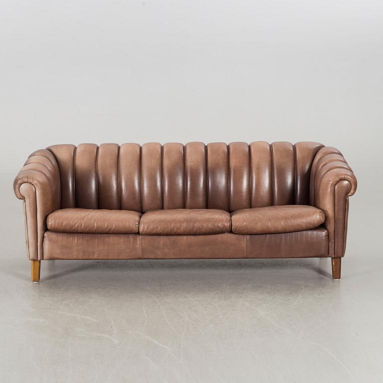 A leather sofa and armchair, 20th century latter part.