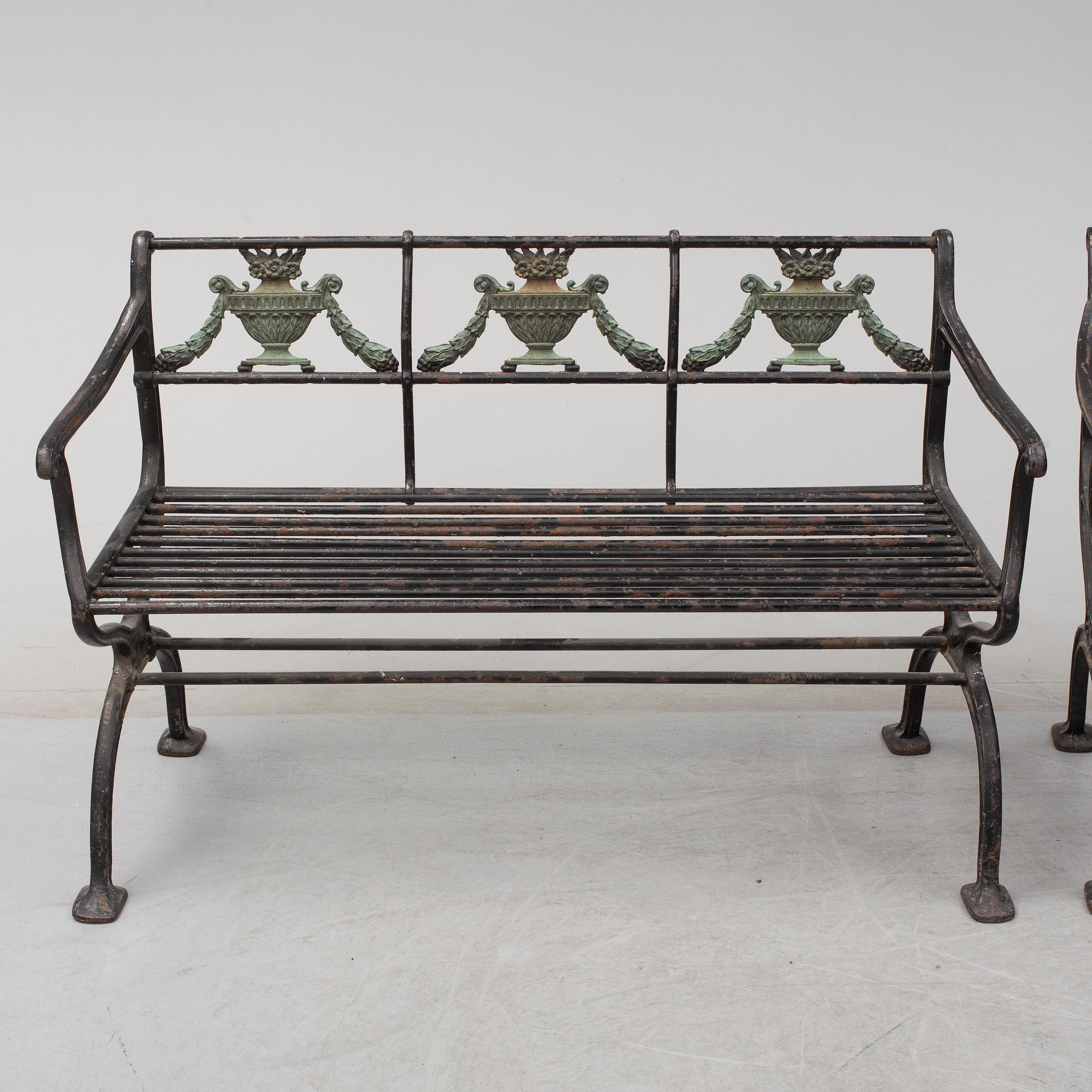 GARDEN SOFAS, a pair, cast iron, empire style, late 19th century.