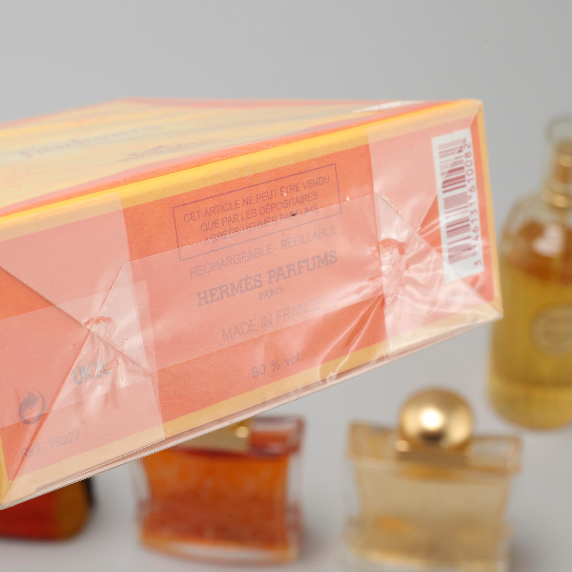 HERMÈS, seven factices and one perfumebottle.