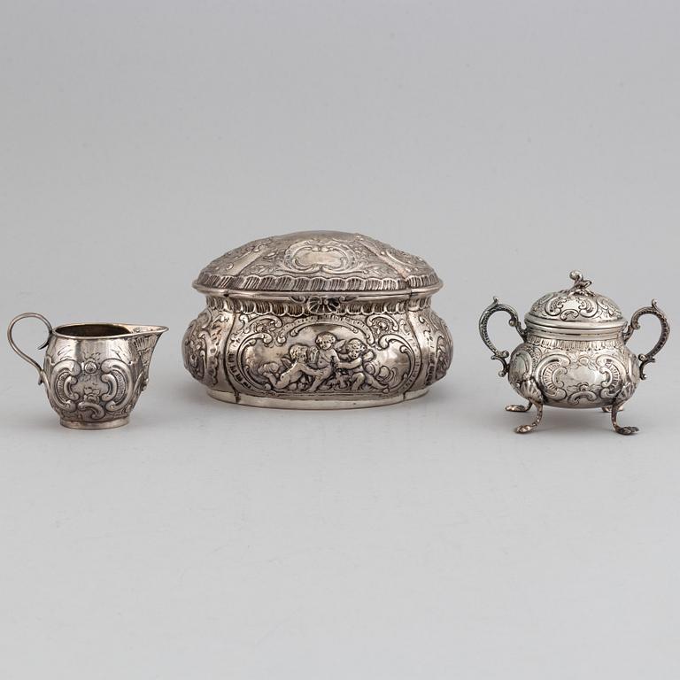 A german silver 800 sugar box, creamer and sugar bowl.