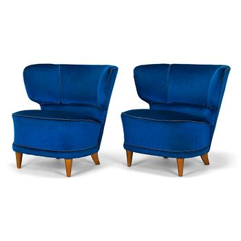 A pair of mid-20th-century armchairs.