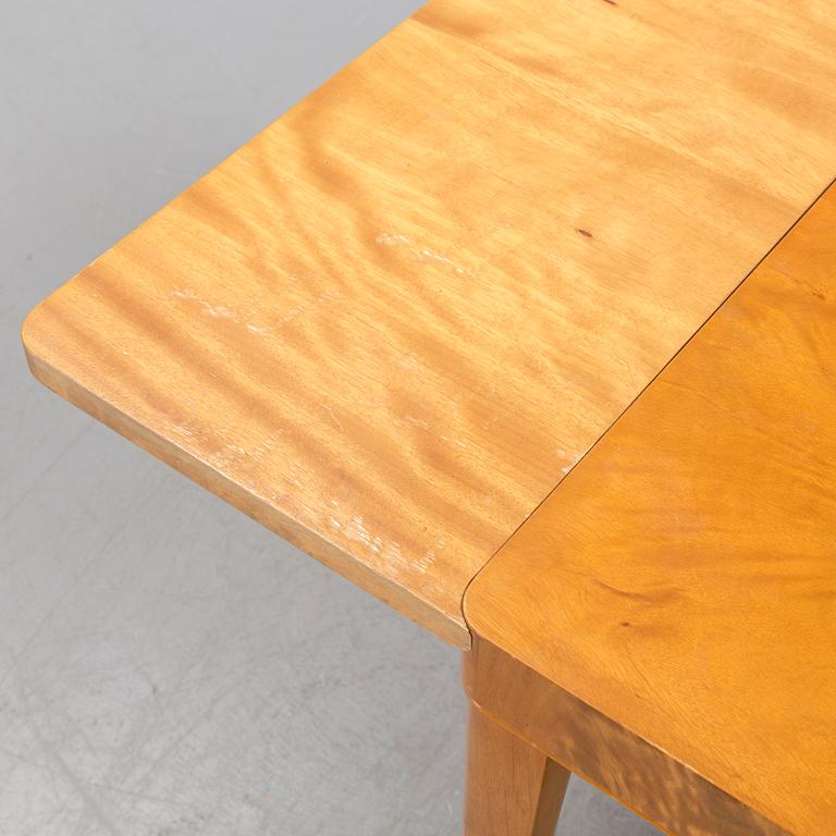 A 1940's dining table an four chairs.