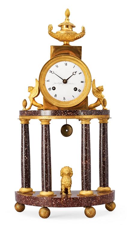 A late Gustavian early 19th century gilt bronze and porphyry mantel clock.