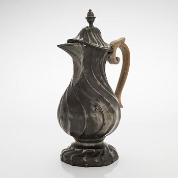 A mid 18th century rococo pewter jug.
