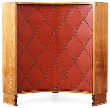 417. An Otto Schulz elm corner cabinet, the doors with red, artificial leather by Boet Gothenburg.