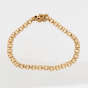 An 18K gold x-link bracelet.