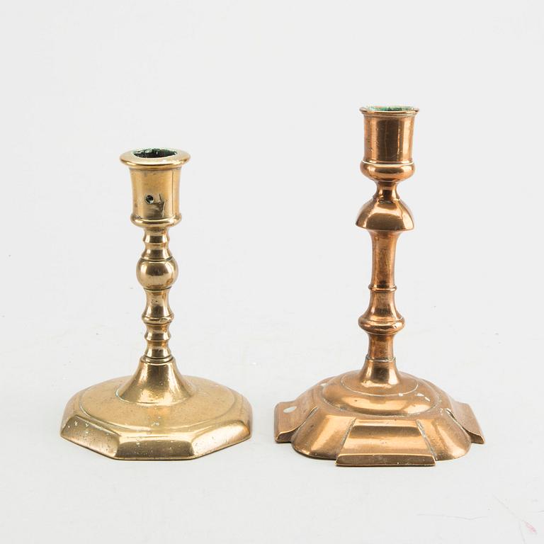 A set of five different brass late Baroque candlesticks.