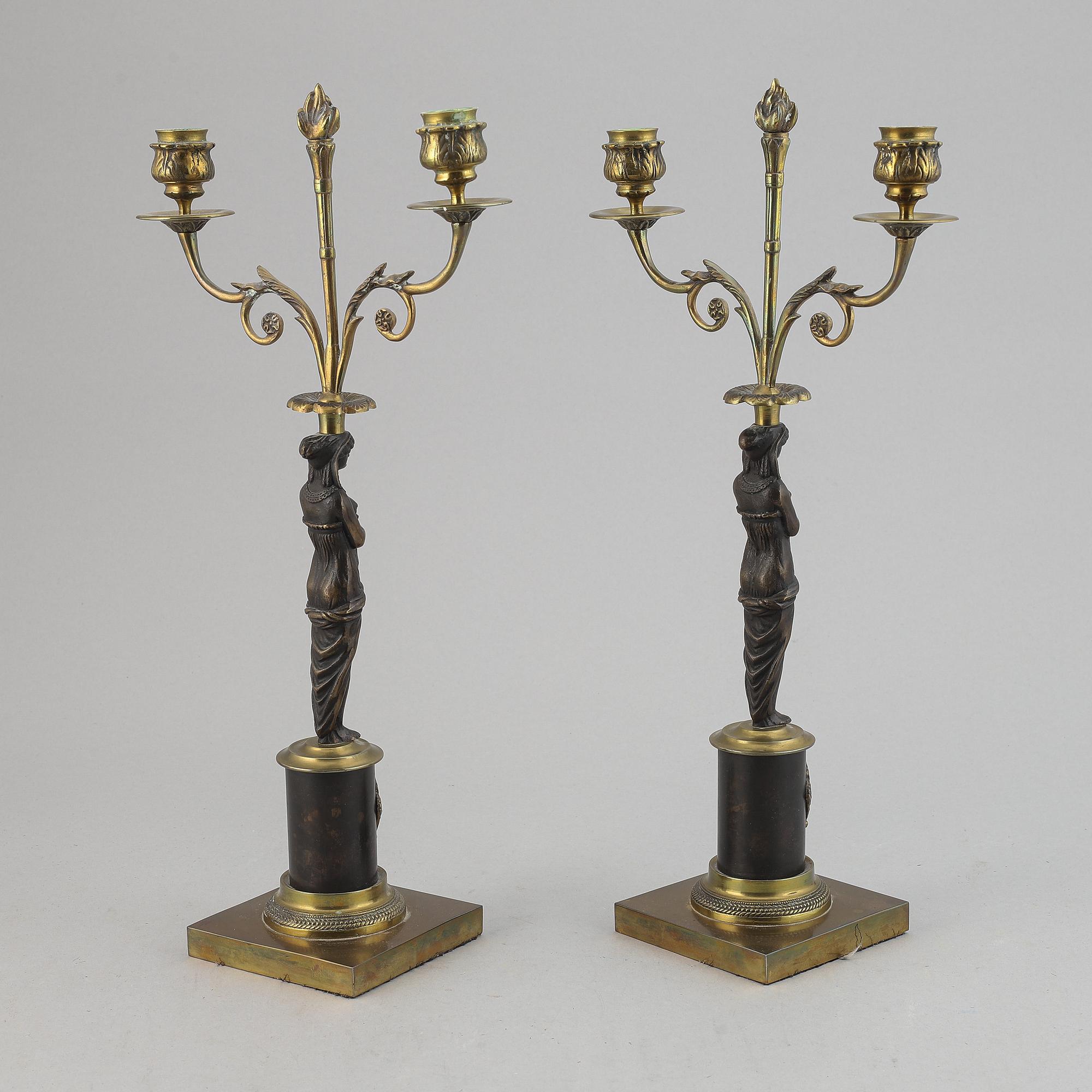 A pair of brass Empire style candle holders, 20th century.