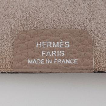 HERMÈS, a taupe veau togo leather notebook, "Ulysse Petit Modèle".