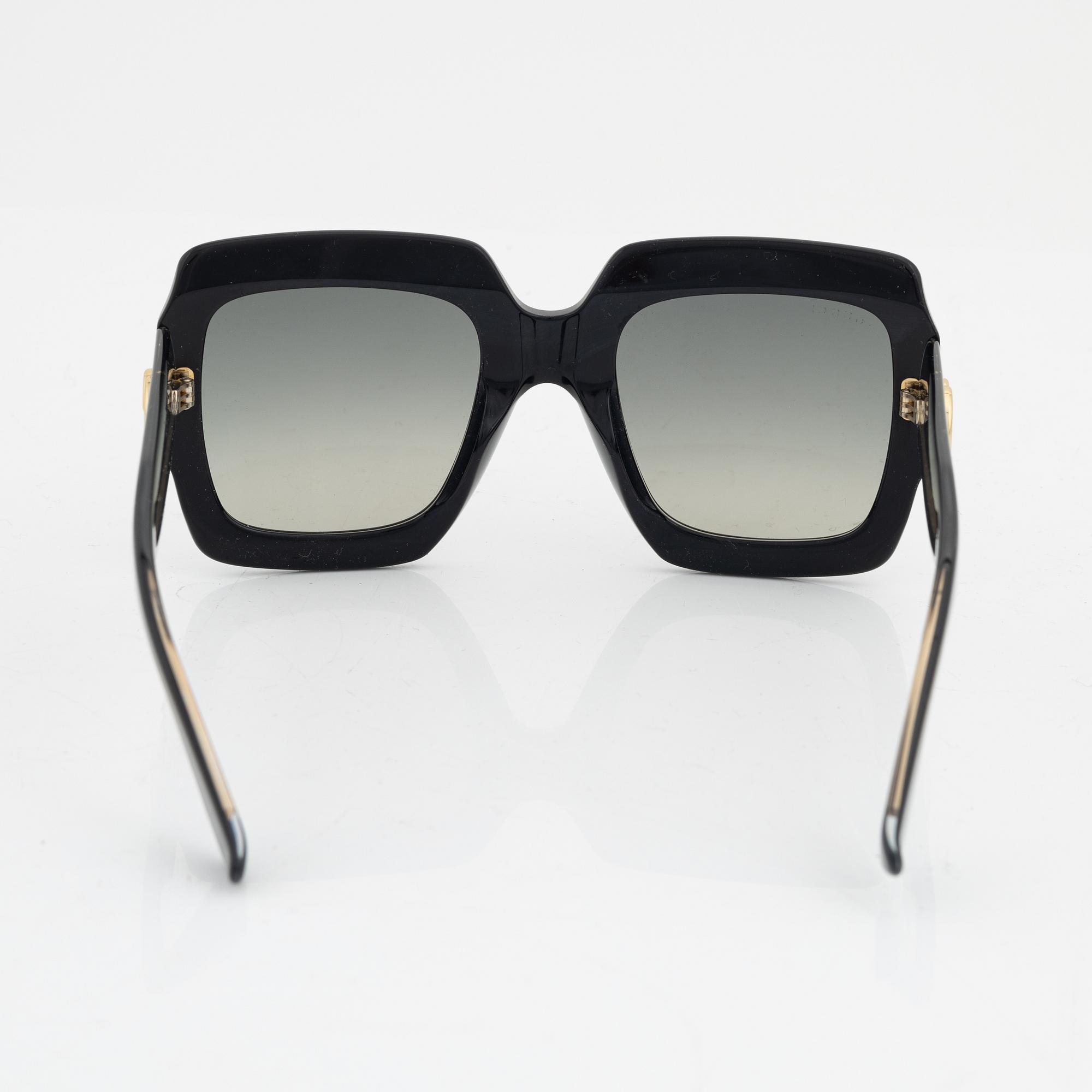 Gucci, a pair of black plastic and rhinestone sunglasses.