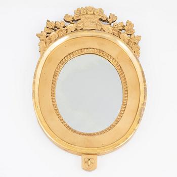 An Empire giltwood mirrored wall sconce by J. M. Berg (active in Gothenburg 1803- ca 1837).