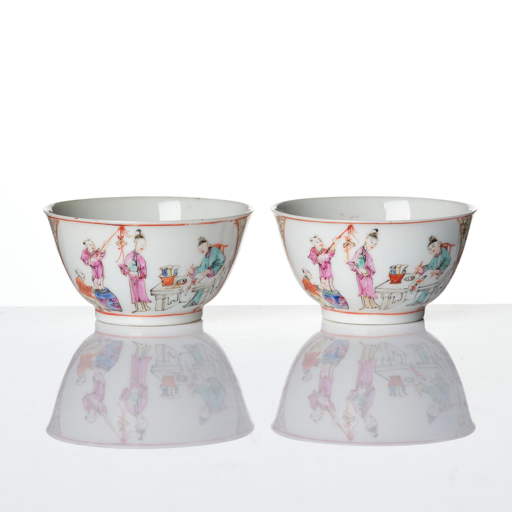 A pair of famille rose 'figural' tea cups with saucers, Qing dynasty, Qianlong (1736-95).