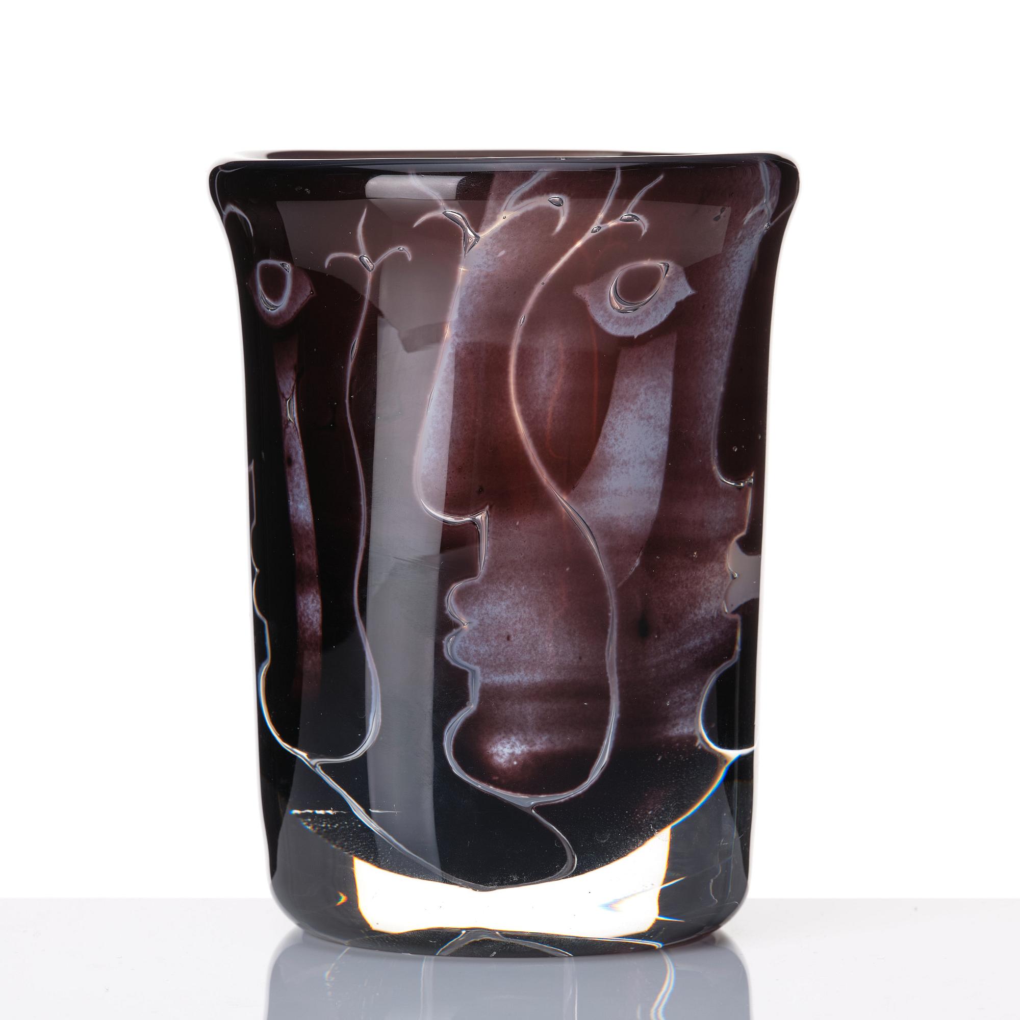 Ingeborg Lundin, an 'ariel' burgundy coloured glass vase decorated with faces, Orrefors Sweden 1972.