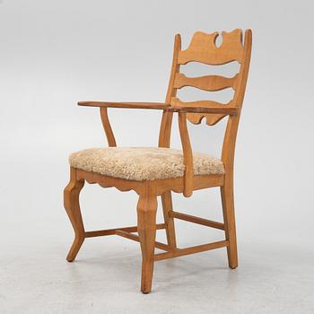 Henning Kjærnulf, an oak 'Razorblade' armchair with new sheepskin upholstery.