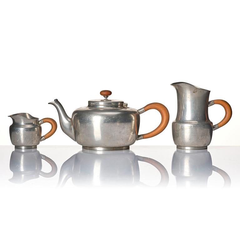 Josef Frank, a four-piece pewter tea set and a plate, model "A2330", Firma Svenskt Tenn, Stockholm 1946 (plate 1929).