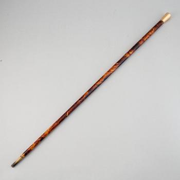 A tortoise imitation veneer, bone, and 14 ct gold walking stick.