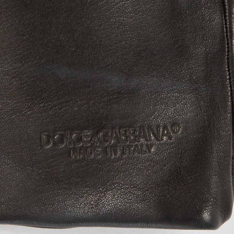 DOLCE & GABBANA, a black leather scarf with ends in the shape of gloves.