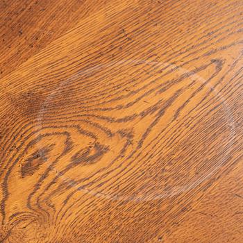 An stained oak dining table with eight chairs.