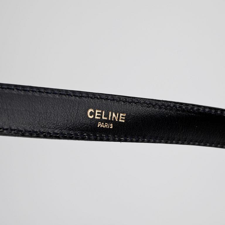 CÉLINE, a dark blue leather belt.
