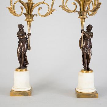 A pair of 19h Century Louis XVI style three-light candelabra in bronze and marble.