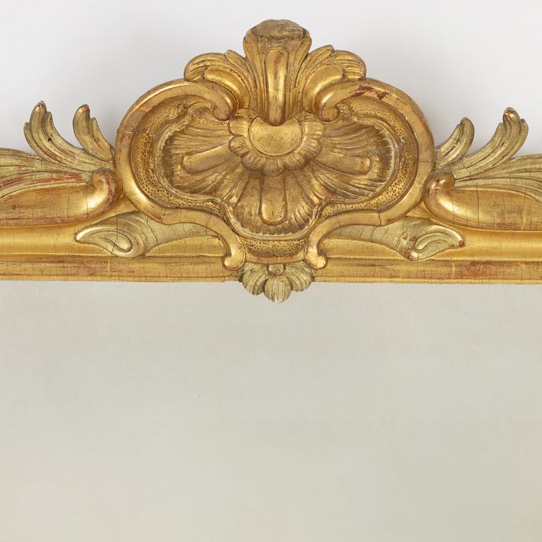 A Gustavian giltwood frame with mirror glass, Stockholm, late 18th century.