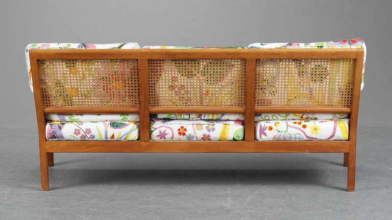 A Josef Frank cherry and ratten sofa for Svenskt Tenn, model 1100.