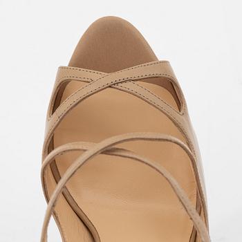 Christian Louboutin, a pair of beige leather sandals, size 37.