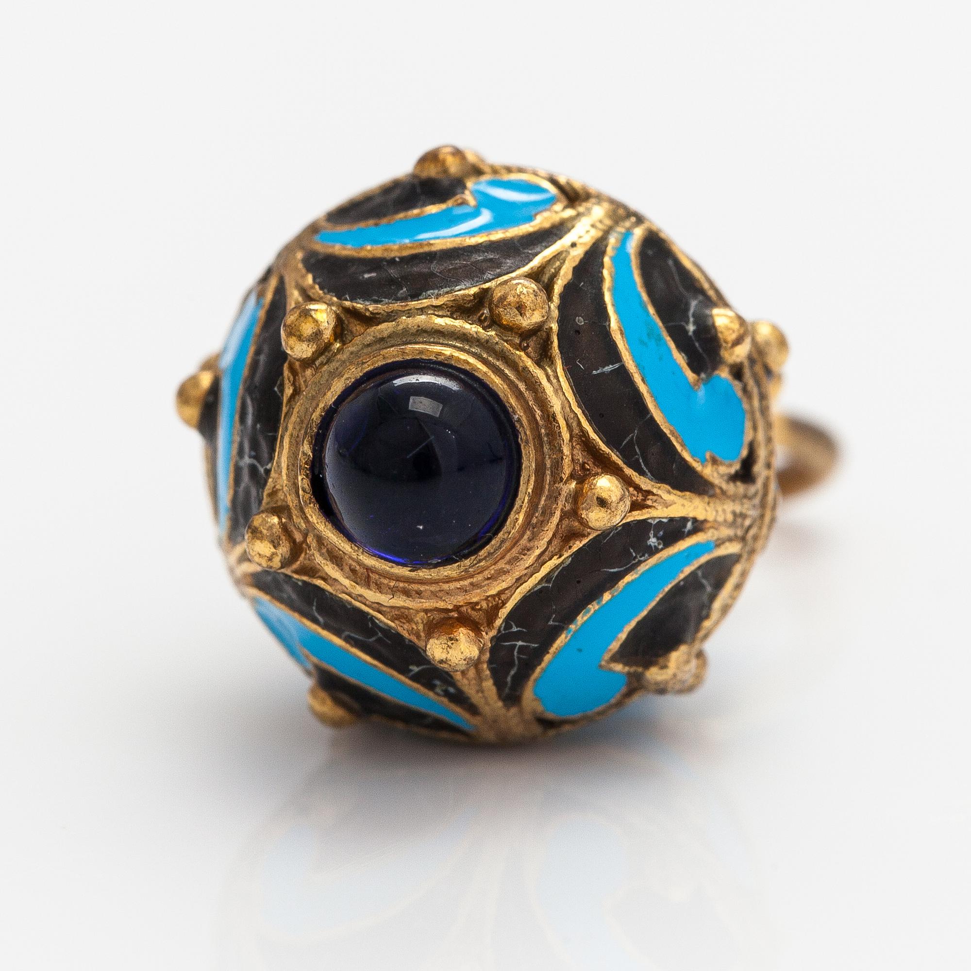 A gilded brass pendant with enamel and glass stones.