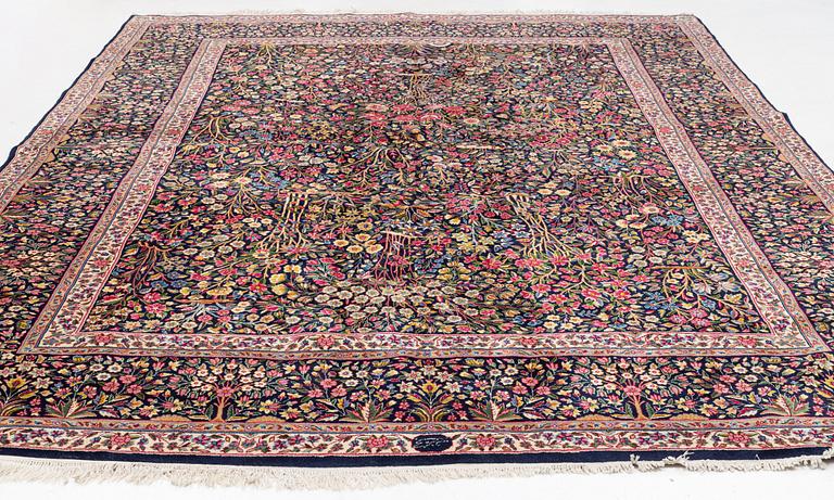 A carpet, Kerman, "Millefleur", signed, ca 396 x 291 cm.