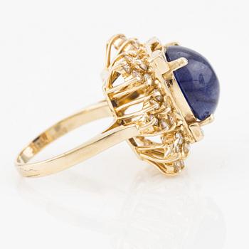 Ring in 14K gold with cabochon-cut sapphire and brilliant-cut diamonds.