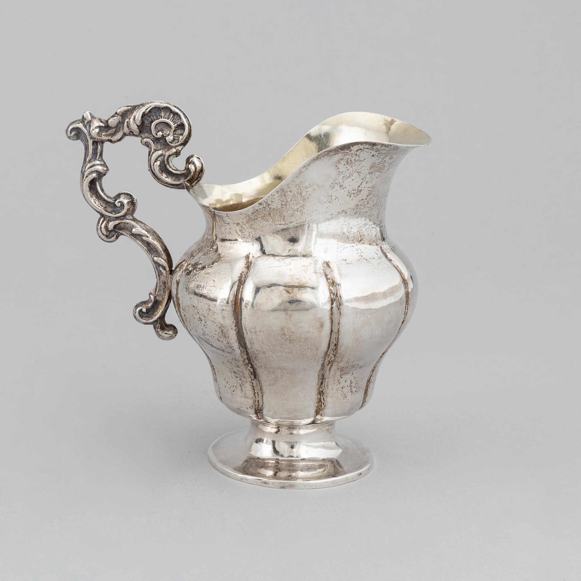 A Swedish 19th century parcel-gilt silver cream-jug, mark of Oskar Ahlström, Södertälje 1856.