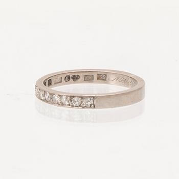 An 18K white gold half-eternity ring set with round single-cut diamonds, Stockholm 1957.