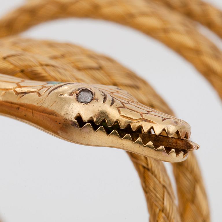 A flexible bracelet. An emerald and rose-cut diamonds on snake head.